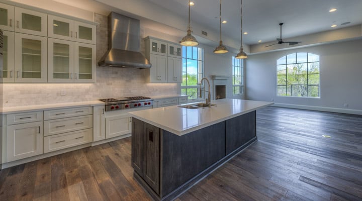 A modern kitchen with stainless steel appliances and wooden cabinets