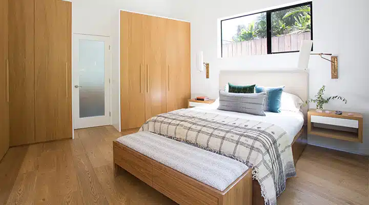 15_620A0065_edited_-720x400 A bedroom with a bed and desk in a room