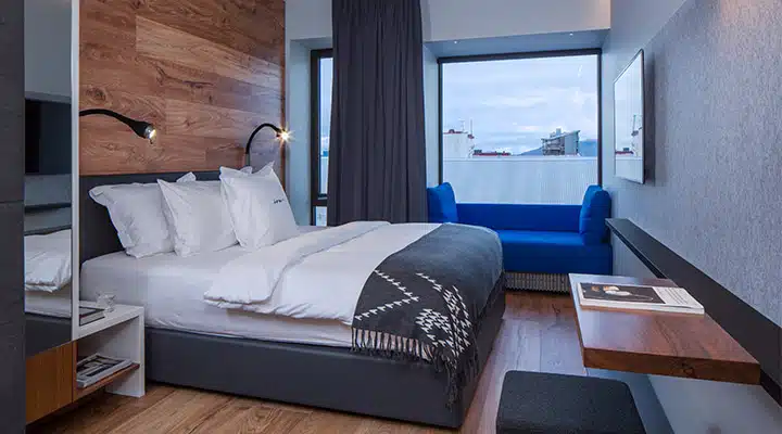 19-Standard-Guestroom-720x400 A bedroom with a bed and desk in a room