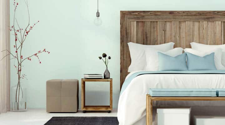 A bedroom with a bed and desk in a room