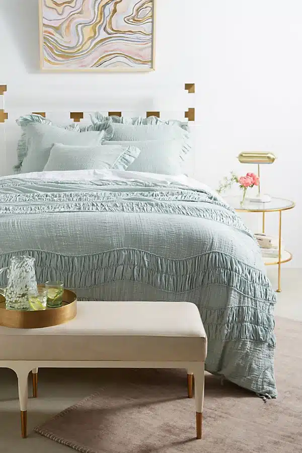 34280552_031_b A bedroom with a bed and a chair in a room