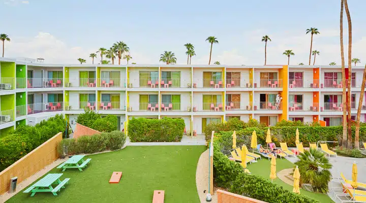 443A1001 A group of people sitting in front of a building