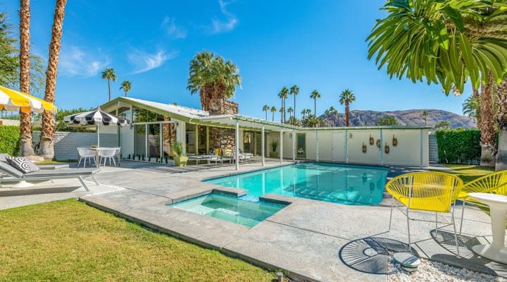 A pool next to a palm tree