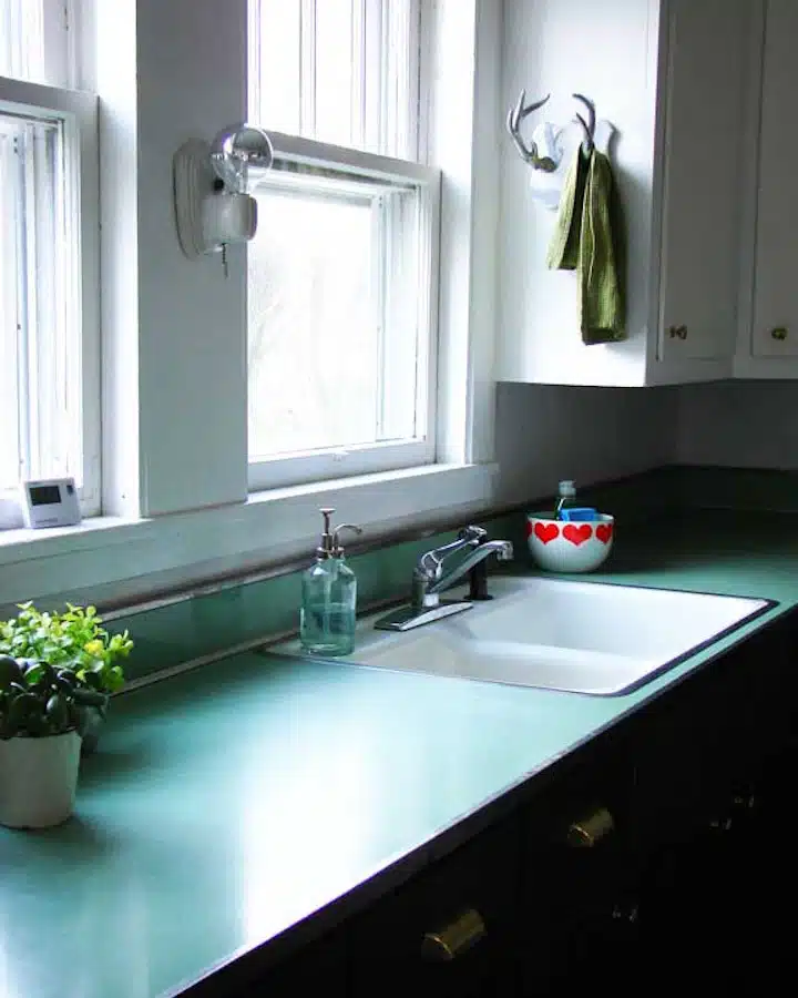 6376745199_60de8c426a_b A kitchen with a sink and a mirror