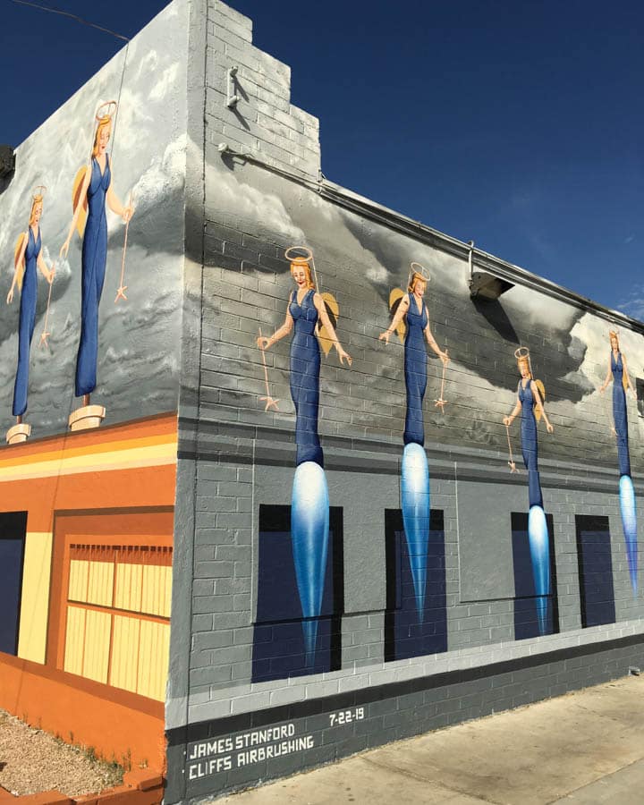 APOAA_East_North_Wall_1-720x900 A group of men standing in front of a building