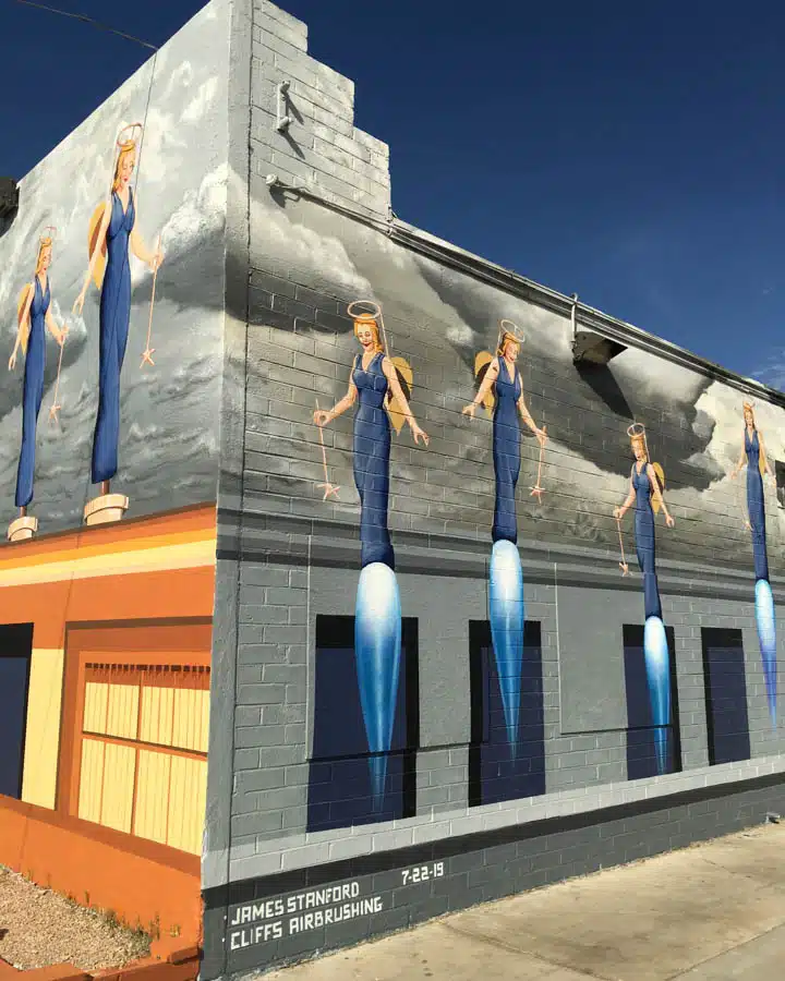 APOAA_East_North_Wall_1-720x900 A group of men standing in front of a building