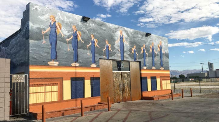 APOAA_East_Wall_1-720x400 A person standing in front of a building