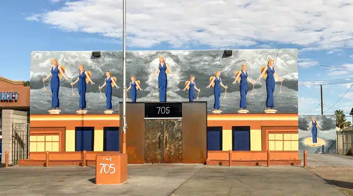 APOAA_East_Wall_2-720x400 A group of people standing in front of a sign