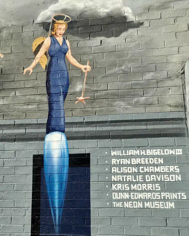 APOAA_North_Wall_DONORS-720x900 A person standing in front of a brick wall