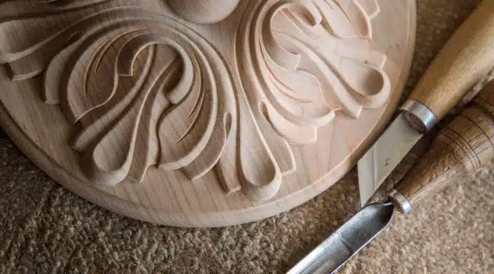 Wood processing. Joinery work. wood carving with work tools clo A close up of a knife