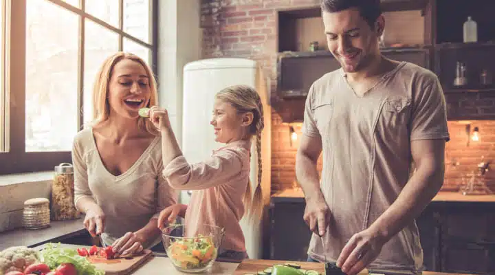 Young family cooking A man and a woman sitting at a table with food