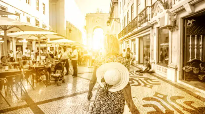Lisbon travel woman A group of people sitting in chairs in front of a building