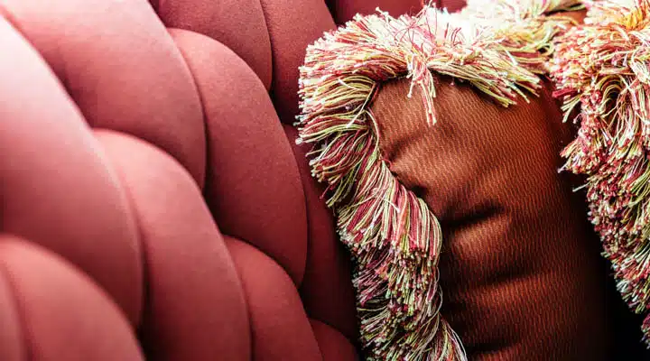 Background of velvet sofa and cushions A close up of a woman