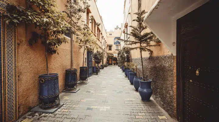 Medina and zoco detail streets in Marrakesh A stone building that has a bench in front of a house