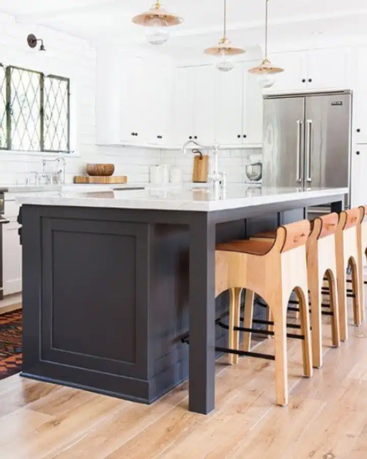Amber-Interiors-Black-Tie A kitchen with wooden cabinets and a wood floor