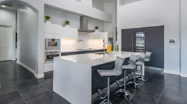 A kitchen with a refrigerator and table in a room