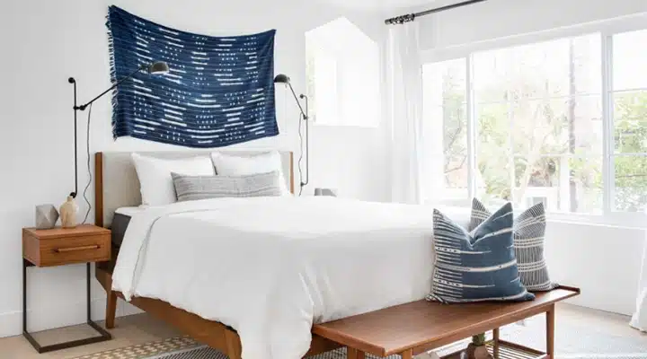 Bedroom-720x400 A bedroom with a bed and a chair in a room