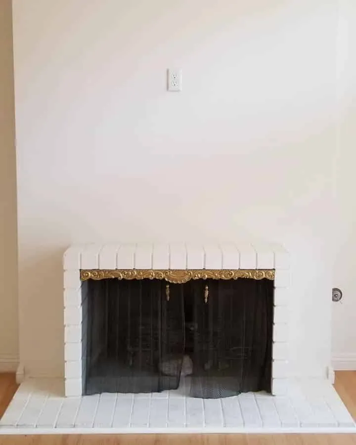 BeforeLivingRMFireplace2-720x900 A building next to a fireplace