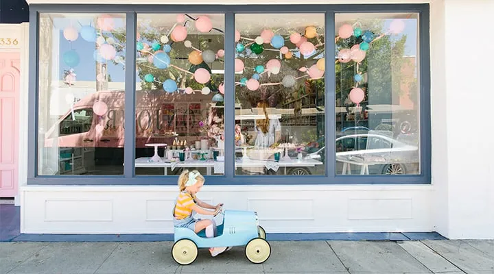 BonjourFete_08292018-0167-720x400 A person sitting on a bench in front of a store
