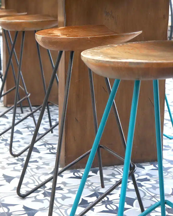 Bright-Accent-Teal-Stool A bird sitting on top of a wooden chair