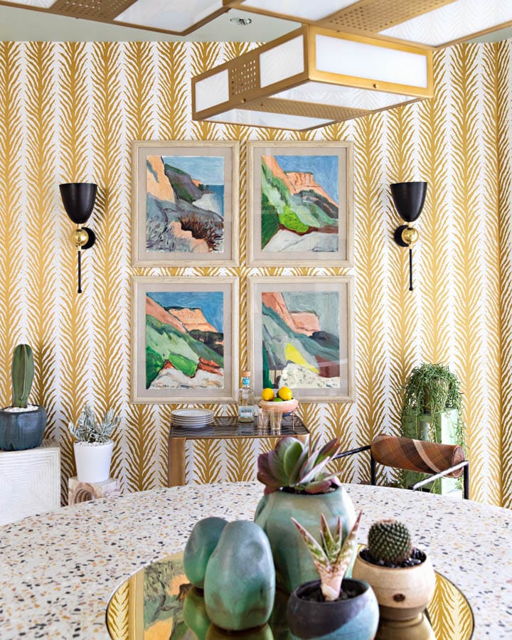 A bedroom with a vase of flowers on a table