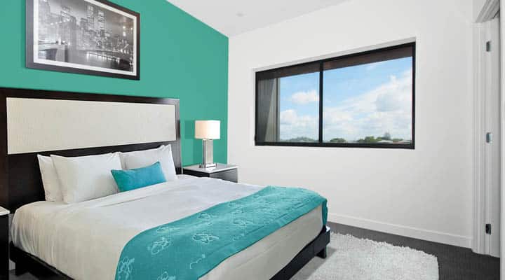 A bedroom with a large bed in a room