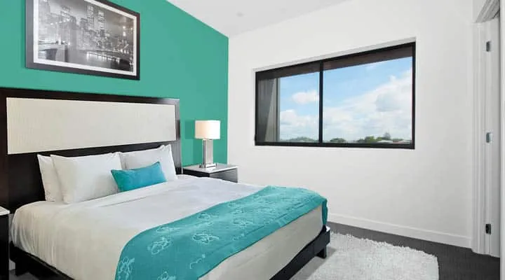 COTM Jul-Dec A bedroom with a large bed in a room