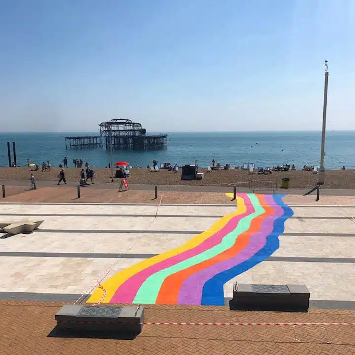 Colourful_crossing_public_art_installation_commissioned_by_Brighton_and_Hove_Council_Photo_by_Lois_OHara-720px A colorful kite sitting on top of a sandy beach