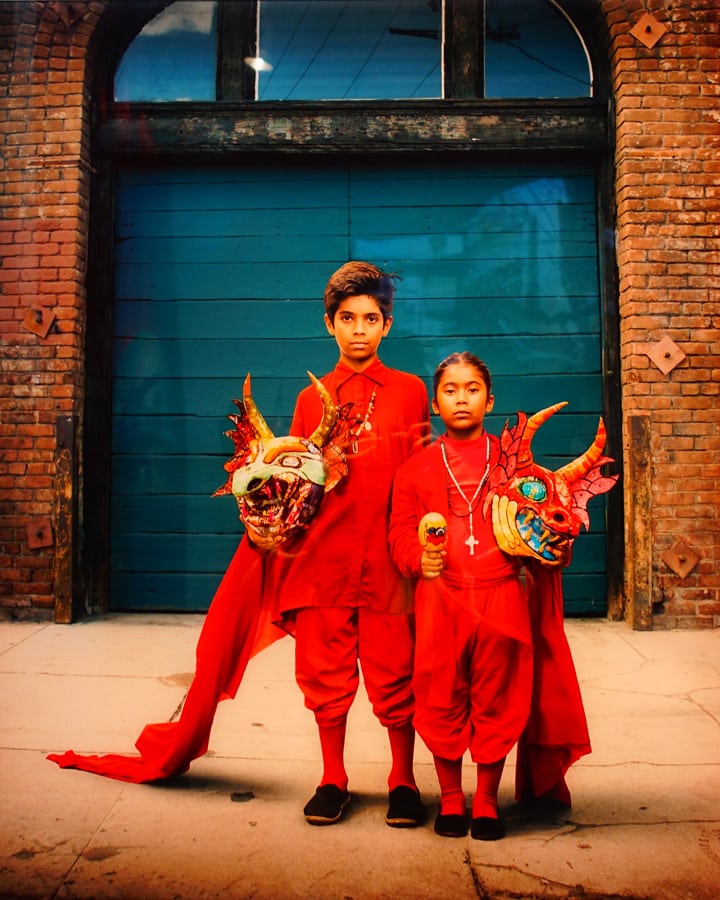 A man and a woman standing in front of a brick building