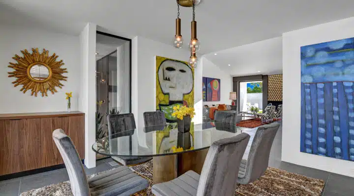 DINING_ROOM_REVERSE-720x400 A living room filled with furniture and a fire place