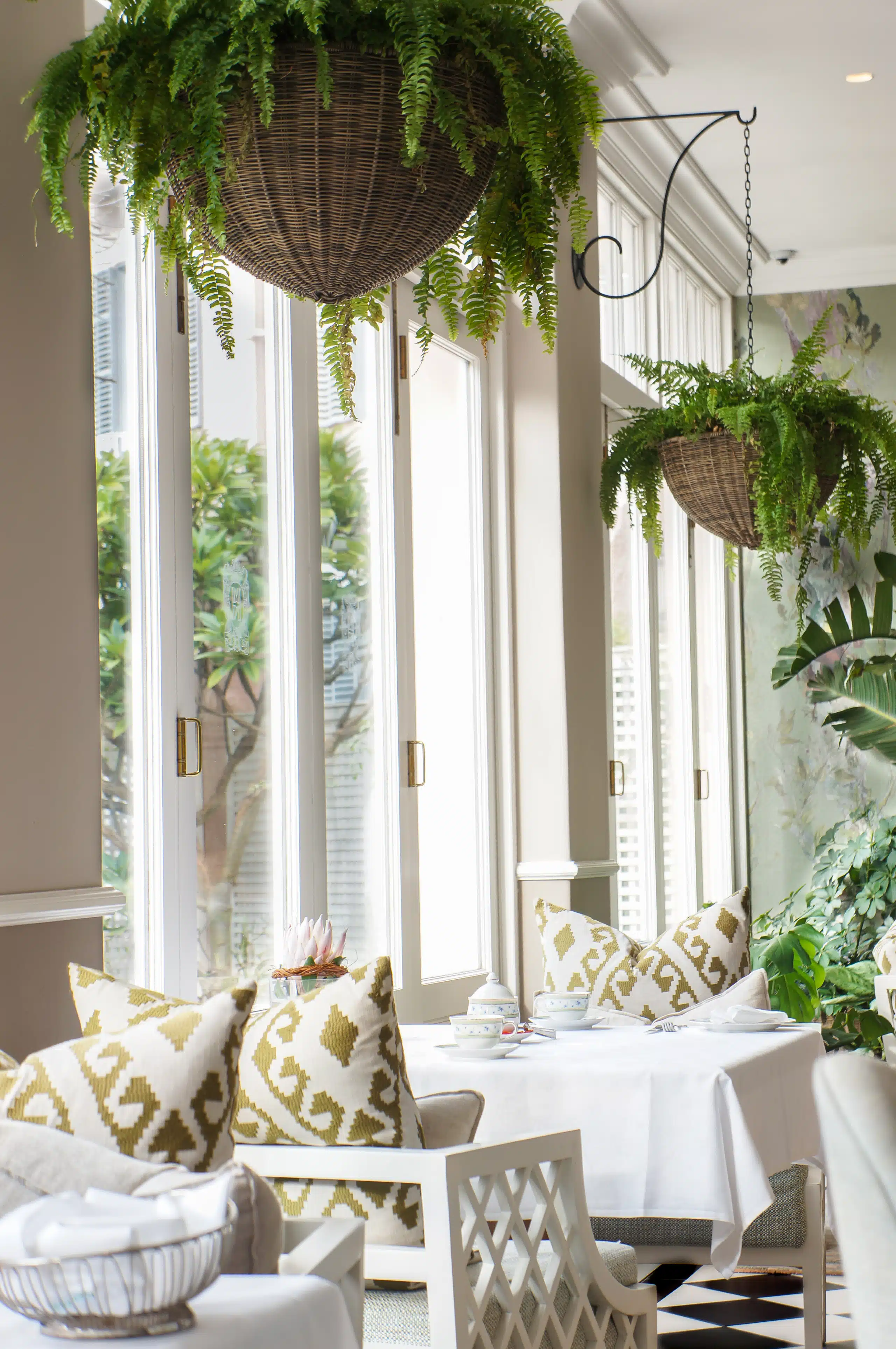 DSC06880 A room filled with furniture and vase of flowers on a table