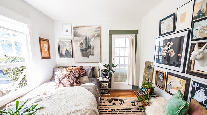 A bedroom with a view of a living room
