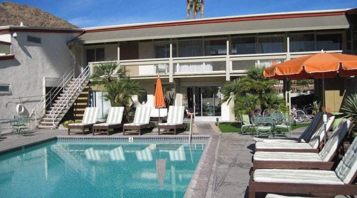 A house with a pool in front of a building