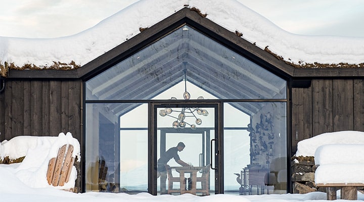 A bedroom with a building in the background
