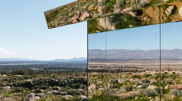 Doug-Aitken-7-Lance-Gerber A herd of sheep standing on top of a grass covered field