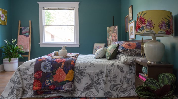 A living room with a bed and a fireplace