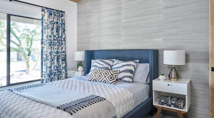 A bedroom with a bed in a room