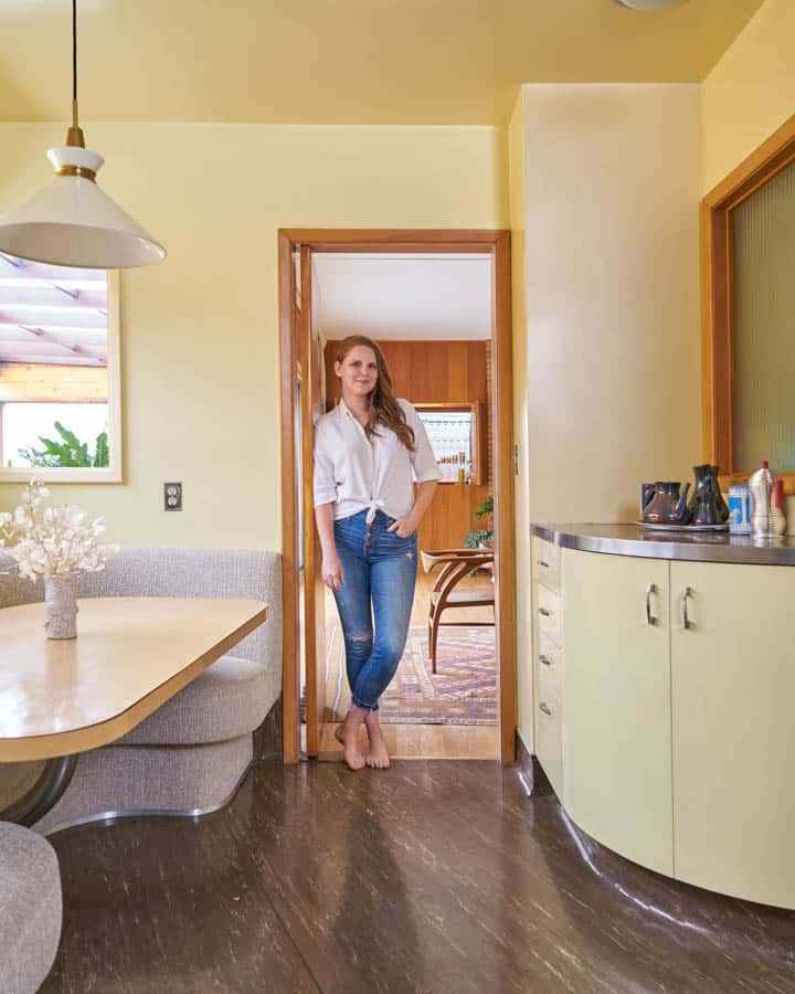 A bedroom with a bed and a mirror