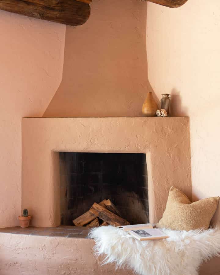 A stove top oven sitting next to a fireplace