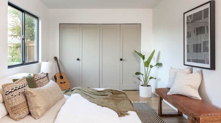 A living room with a bed and a window