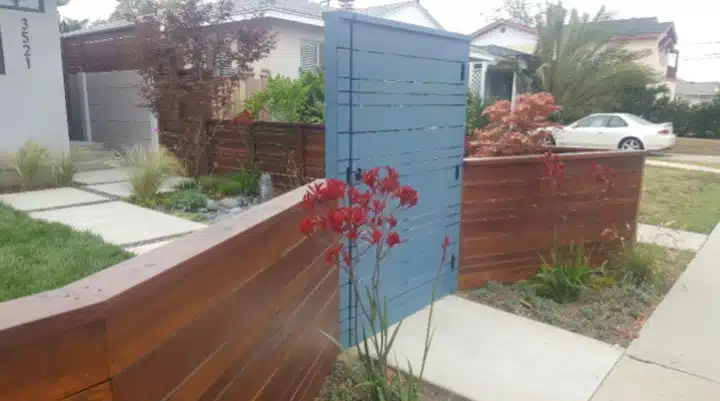 Duration-Painting-Blue-Fence A fire hydrant in front of a house