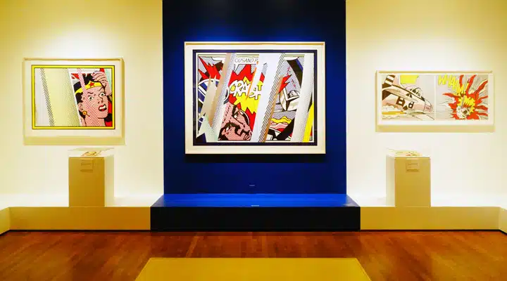 Exhibit A room with art on the wall