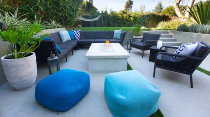 Gabor-Allen-Teal-Patio A living room filled with furniture and vase of flowers on a table