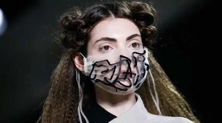 GettyImages-1204661426-720x400 A person wearing glasses and smiling at the camera