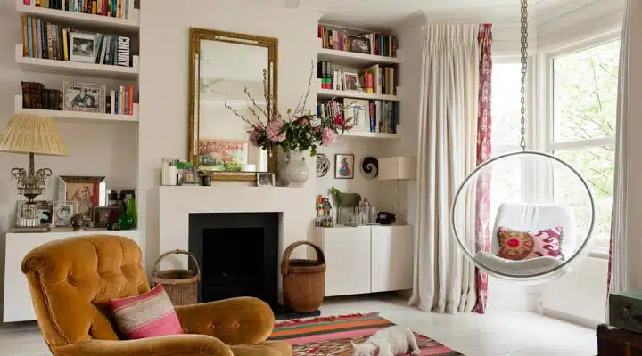 London flat of interior designer Sarah Vanrenen A living room filled with furniture and a fire place
