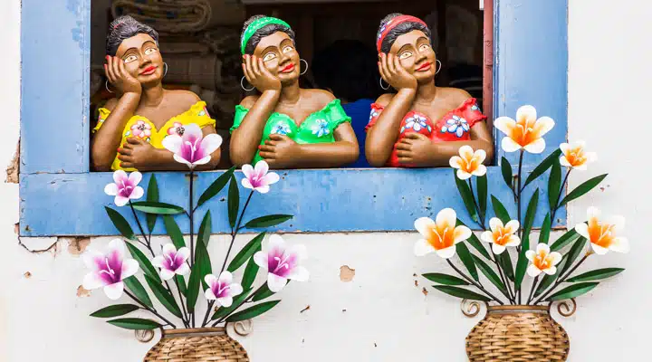 GettyImages-541327448_full A group of people sitting at a table with a vase of colorful flowers