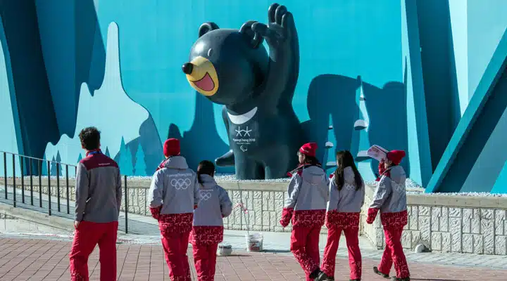 GettyImages-912893642_comp_1024 A group of people standing next to a fence