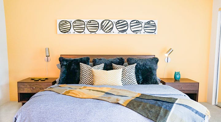 A bedroom with a bed in a room