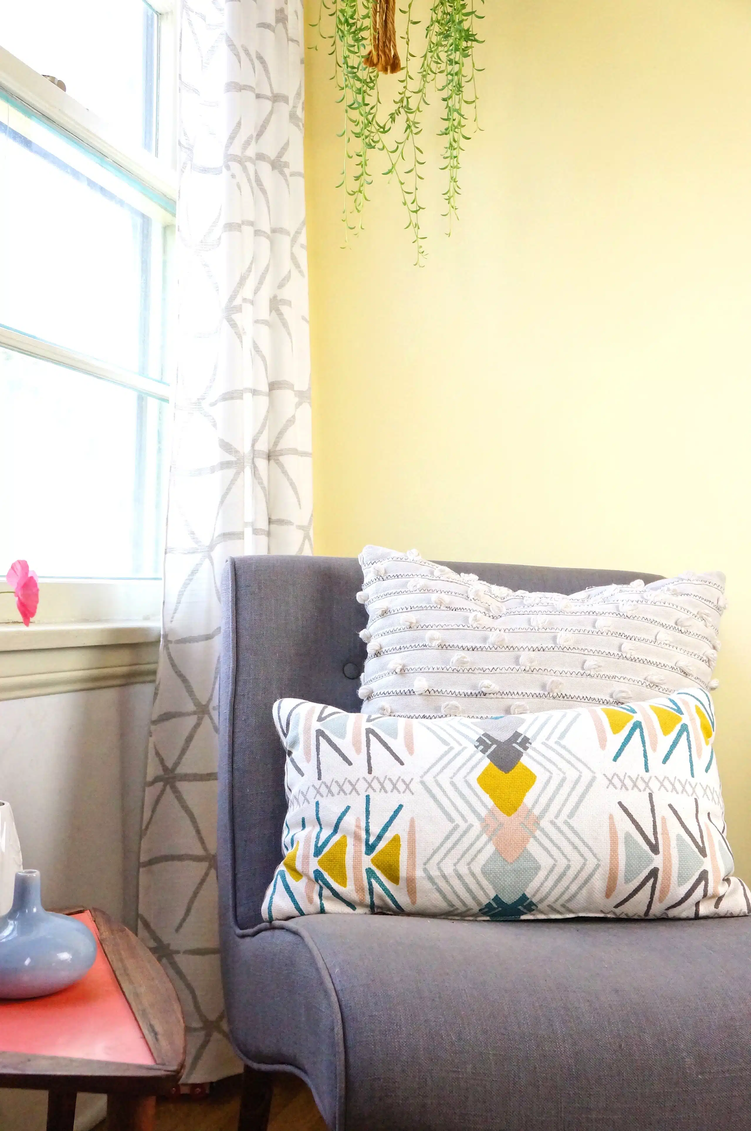 A living room filled with furniture and vase of flowers on a table