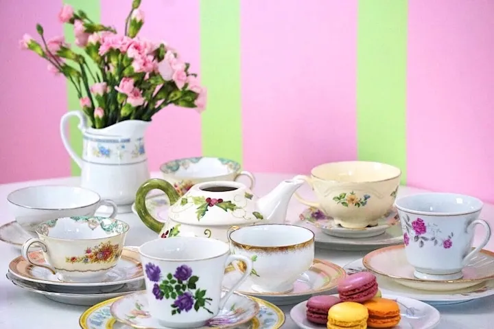 IMG_5381 A cup of coffee and a vase of flowers on a table